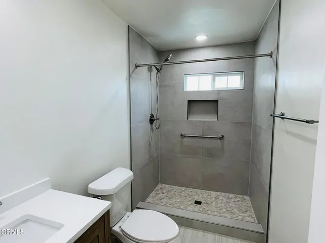 a bathroom with a shower and a toilet
