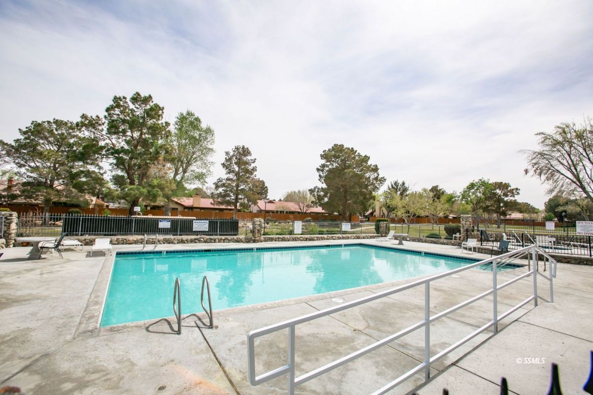 425 Mt Shasta Circle Ridgecrest, CA 93555 - Photo 38 of 47 a view of a swimming pool with outdoor seating and yard in the back