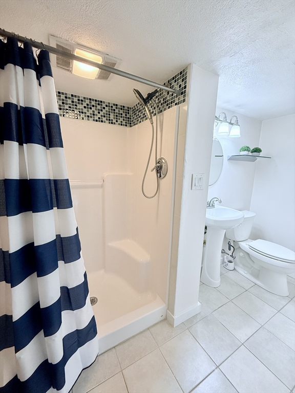 975 South Main Street Bellingham, MA 02019 - Photo 19 of 38 a bathroom with a bathtub and a shower