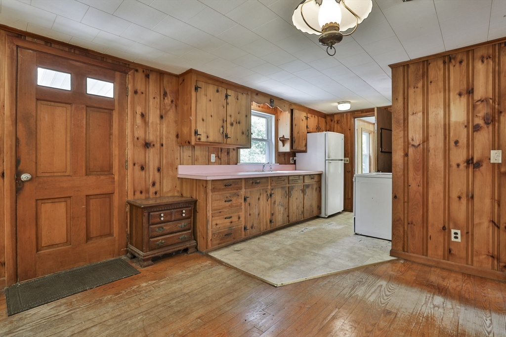 4 Cross Street Windham, NH 03087 - Photo 7 of 30 a view of kitchen with stainless steel appliances granite countertop a refrigerator a sink dishwasher a dining table and chairs with wooden floor