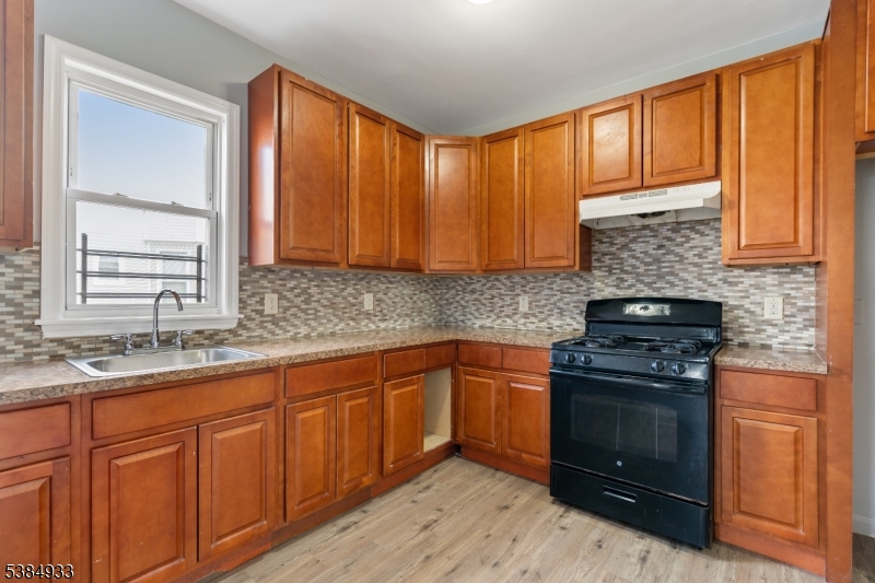 87 Columbia Avenue, Unit 3 Newark, NJ 07106 - Photo 6 of 9 a kitchen with granite countertop cabinets stainless steel appliances and a sink