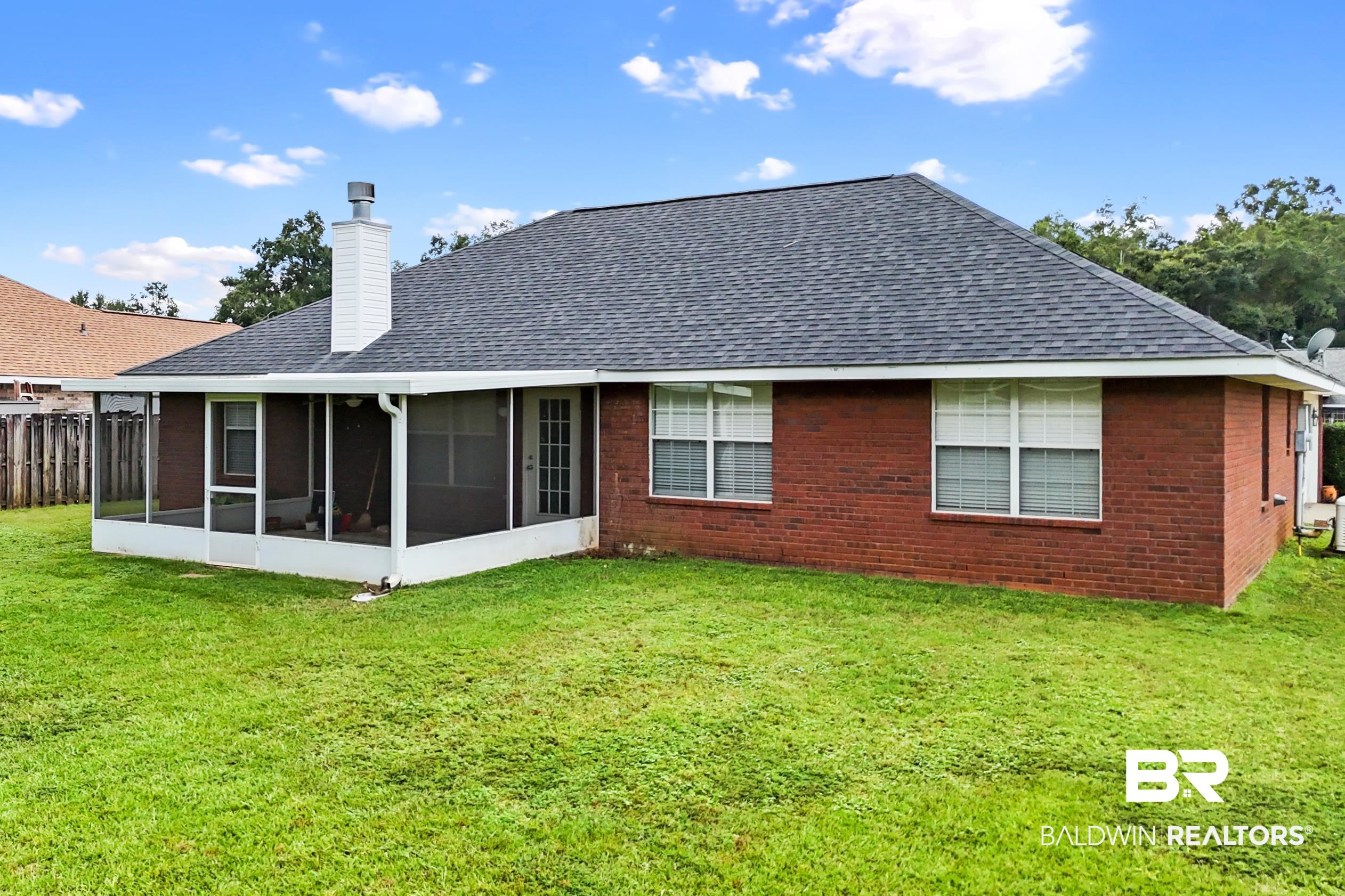 306 Monteith Oaks Drive Foley, AL 36535 - Photo 28 of 38 Rear view of property with a yard, a sunroom, roof with shingles, and a chimney