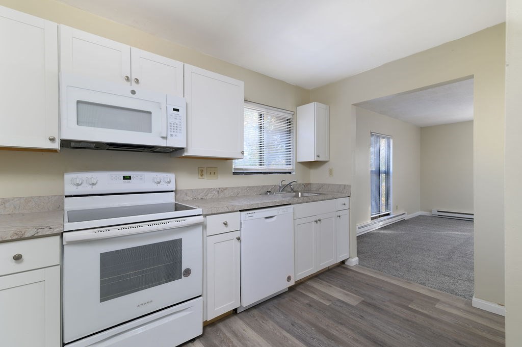 800 Bearses Way, Unit 2SF Hyannis, MA 02601 - Photo 9 of 23 a kitchen with granite countertop white cabinets white stainless steel appliances and granite counter tops