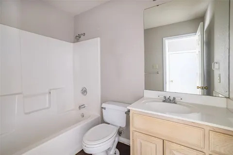 a bathroom with a sink toilet vanity and shower