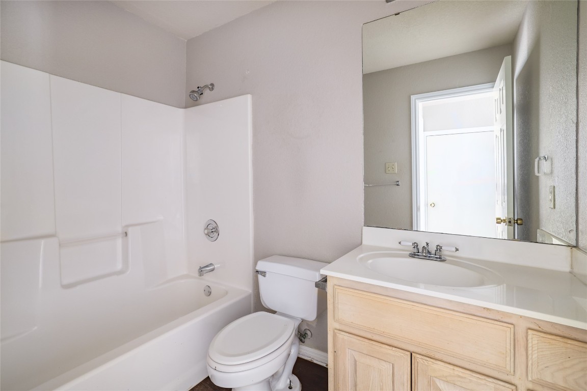 2509 Riddle Road Austin, TX 78748 - Photo 11 of 16 a bathroom with a sink toilet vanity and shower