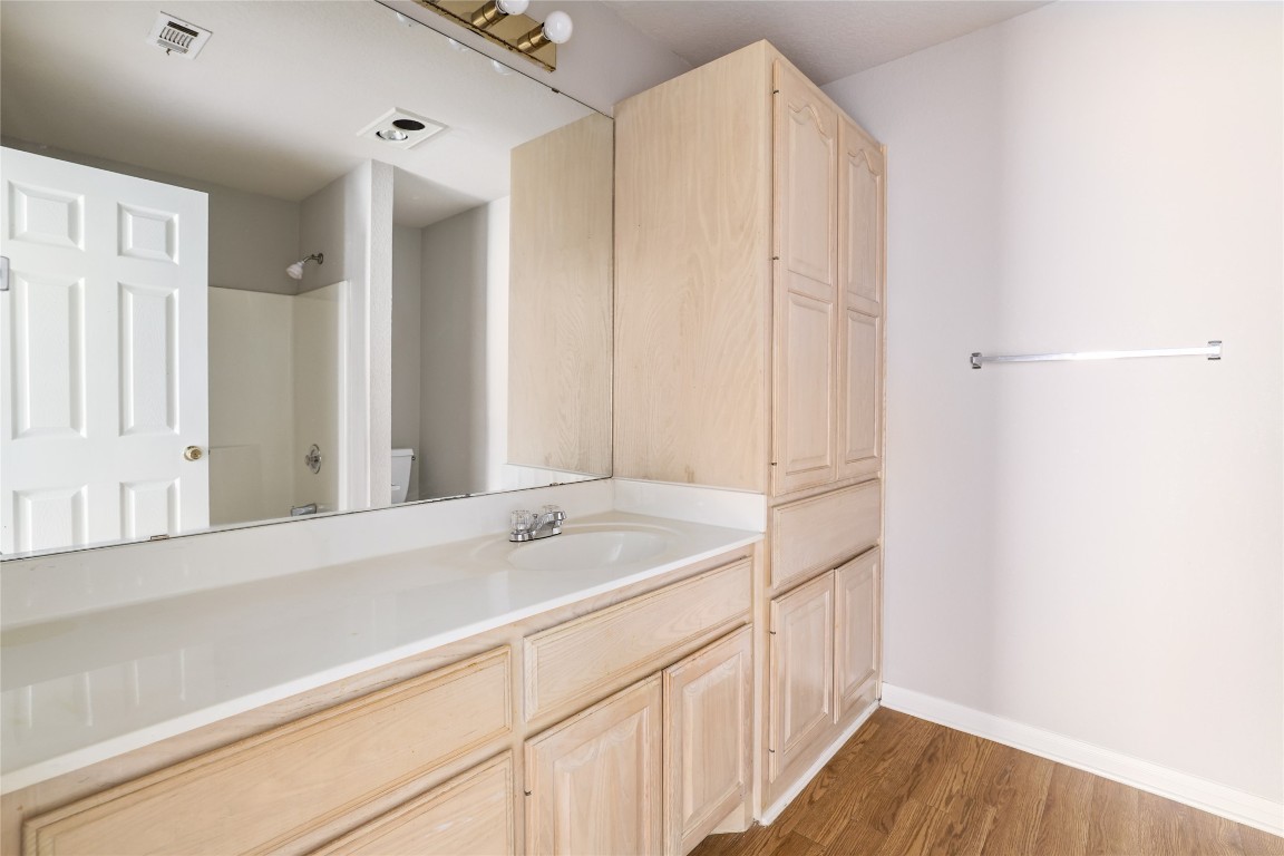 2509 Riddle Road Austin, TX 78748 - Photo 13 of 16 a bathroom with a sink and a mirror