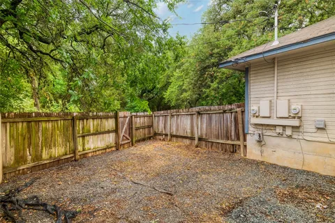 a view of a backyard with wooden fence