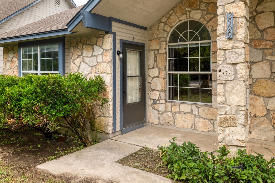 2509 Riddle Road Austin, TX 78748 - Photo 3 of 16 front view of a brick house with a large door