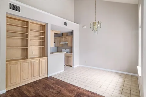 a room with a white cabinets and wooden floor