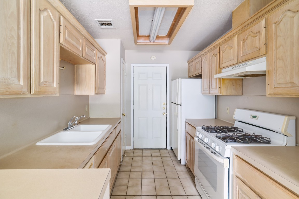 2509 Riddle Road Austin, TX 78748 - Photo 9 of 16 a kitchen with stainless steel appliances a stove a sink and a refrigerator