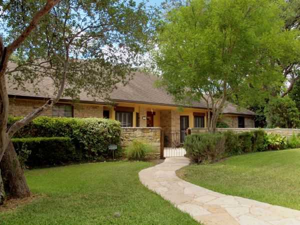 a front view of house with yard and green space