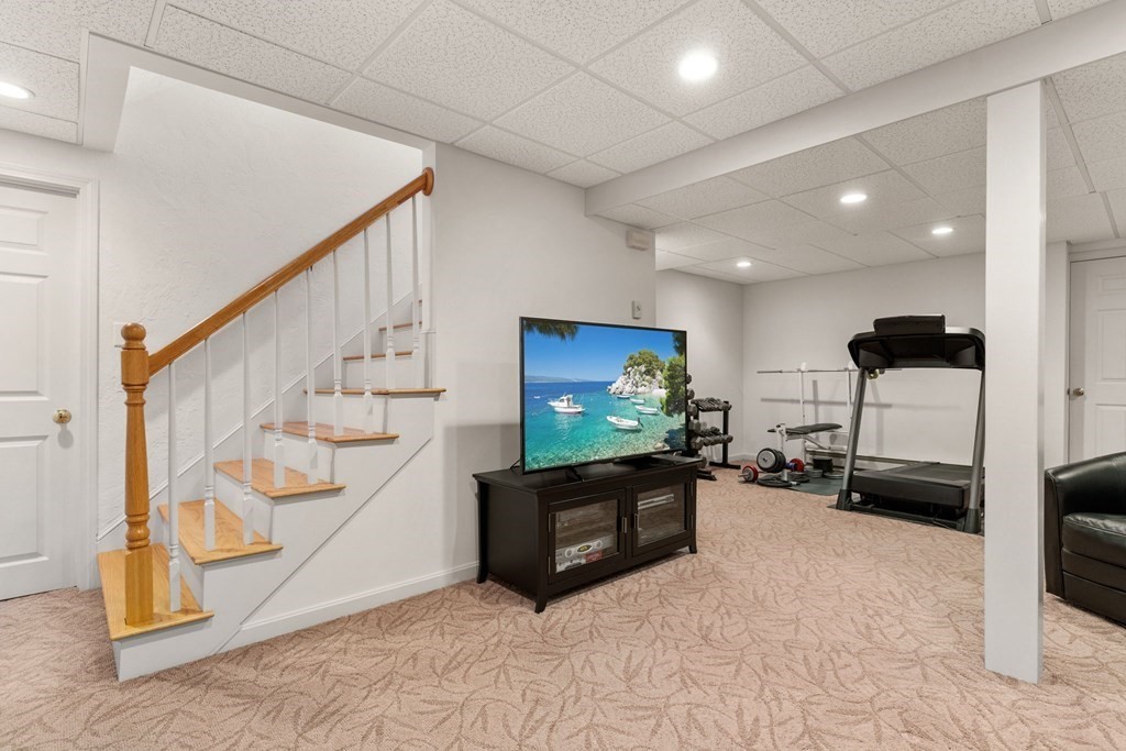 628 Boston Road Groton, MA 01450 - Photo 21 of 32 a view of a livingroom with furniture and a flat screen tv