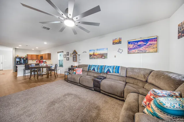 a living room with furniture and a chandelier