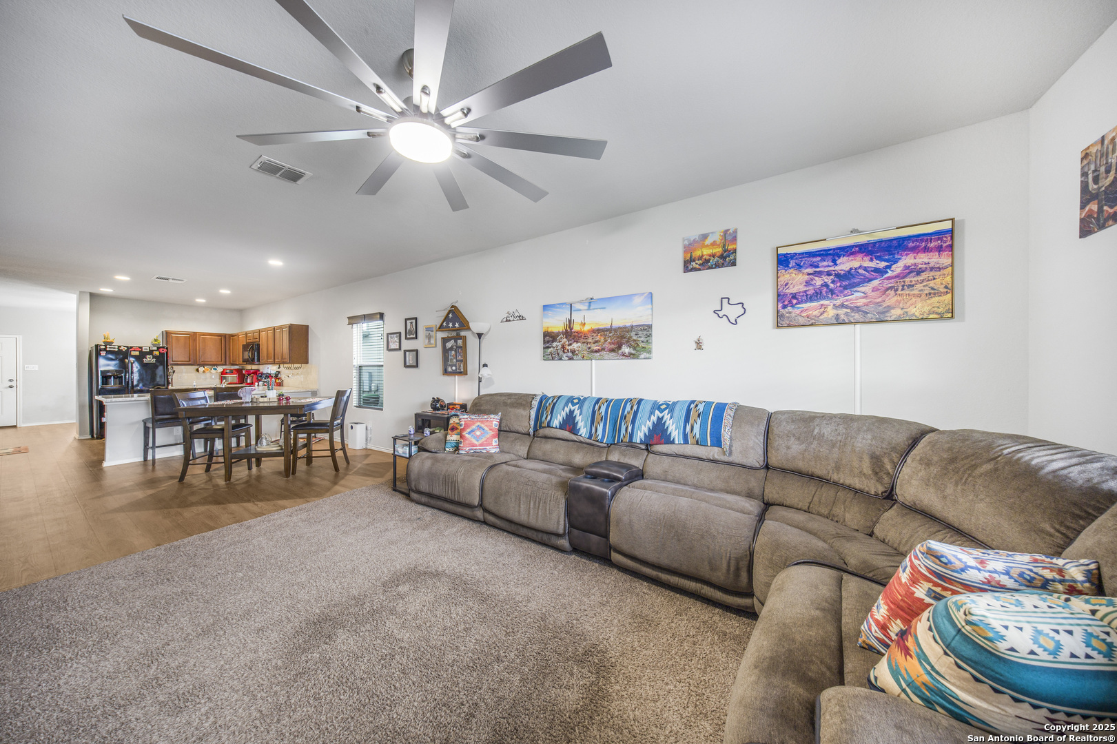 13115 Heathers Reef St. Hedwig, TX 78152 - Photo 13 of 23 a living room with furniture and a chandelier