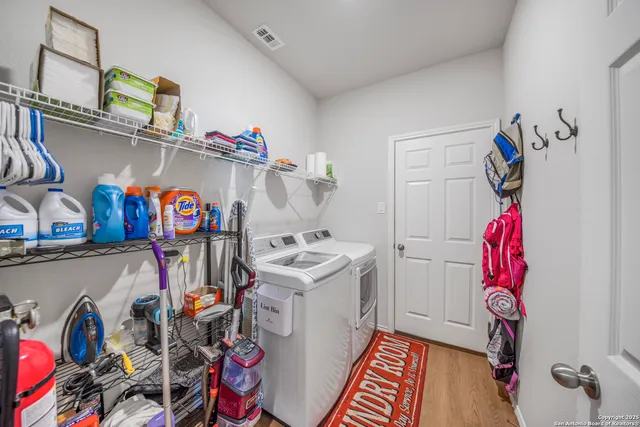 a utility room with fridge and closet