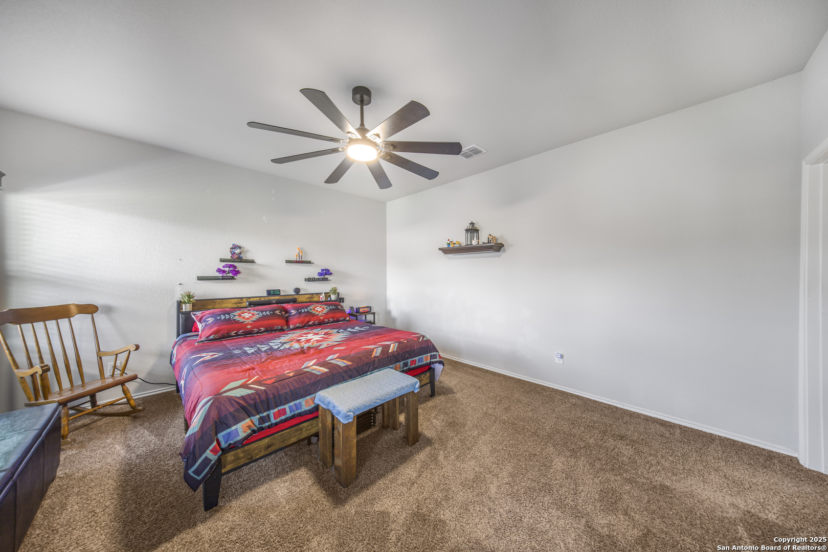 13115 Heathers Reef St. Hedwig, TX 78152 - Photo 18 of 23 a bedroom with a bed and a chandelier