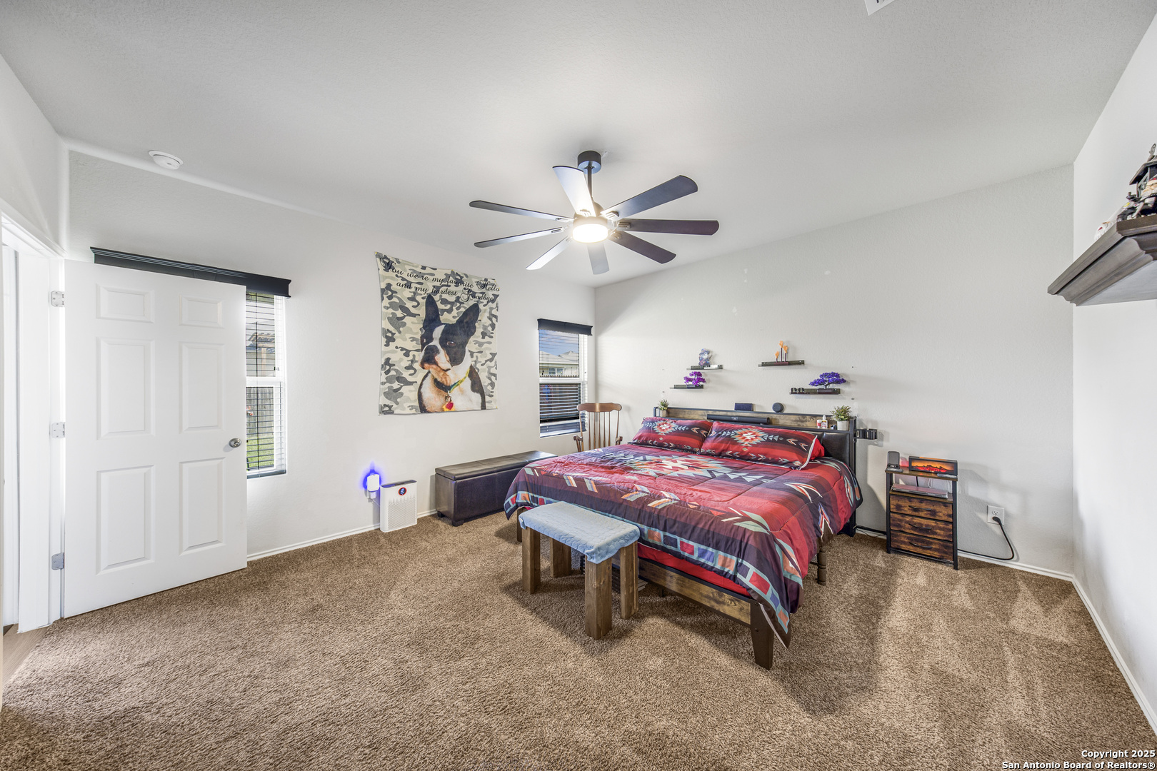 13115 Heathers Reef St. Hedwig, TX 78152 - Photo 19 of 23 a bedroom with a bed and a chandelier