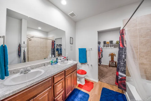 a bathroom with a sink vanity granite and a mirror