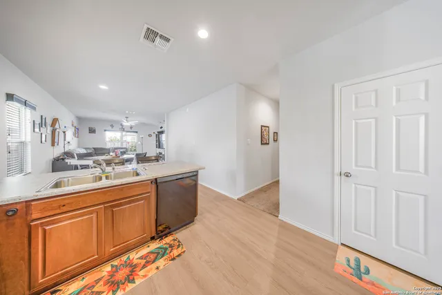 a kitchen with stainless steel appliances granite countertop a sink and cabinets