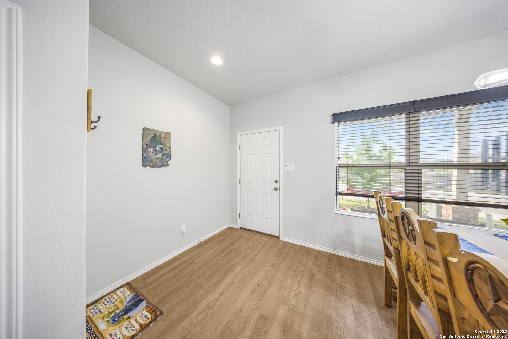 13115 Heathers Reef St. Hedwig, TX 78152 - Photo 7 of 23 a view of a room with wooden floor and windows