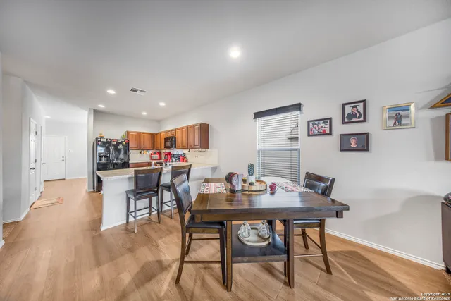 a dining room with furniture and a kitchen view