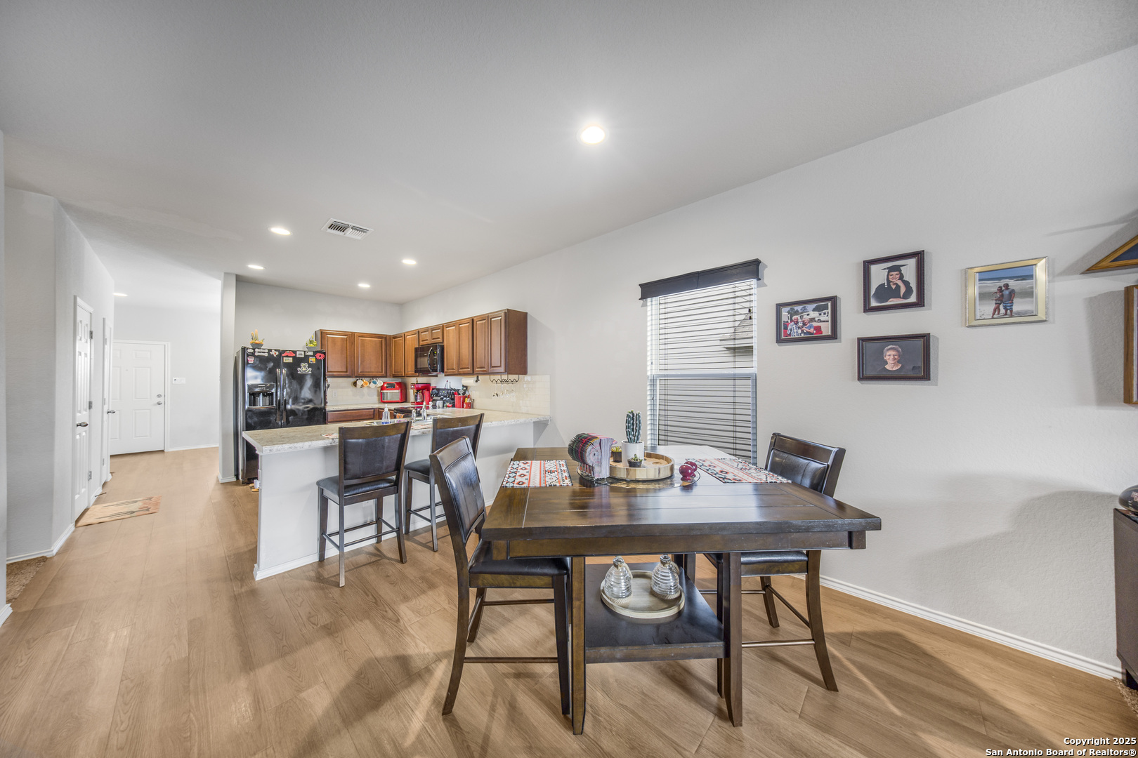 13115 Heathers Reef St. Hedwig, TX 78152 - Photo 10 of 23 a dining room with furniture and a kitchen view