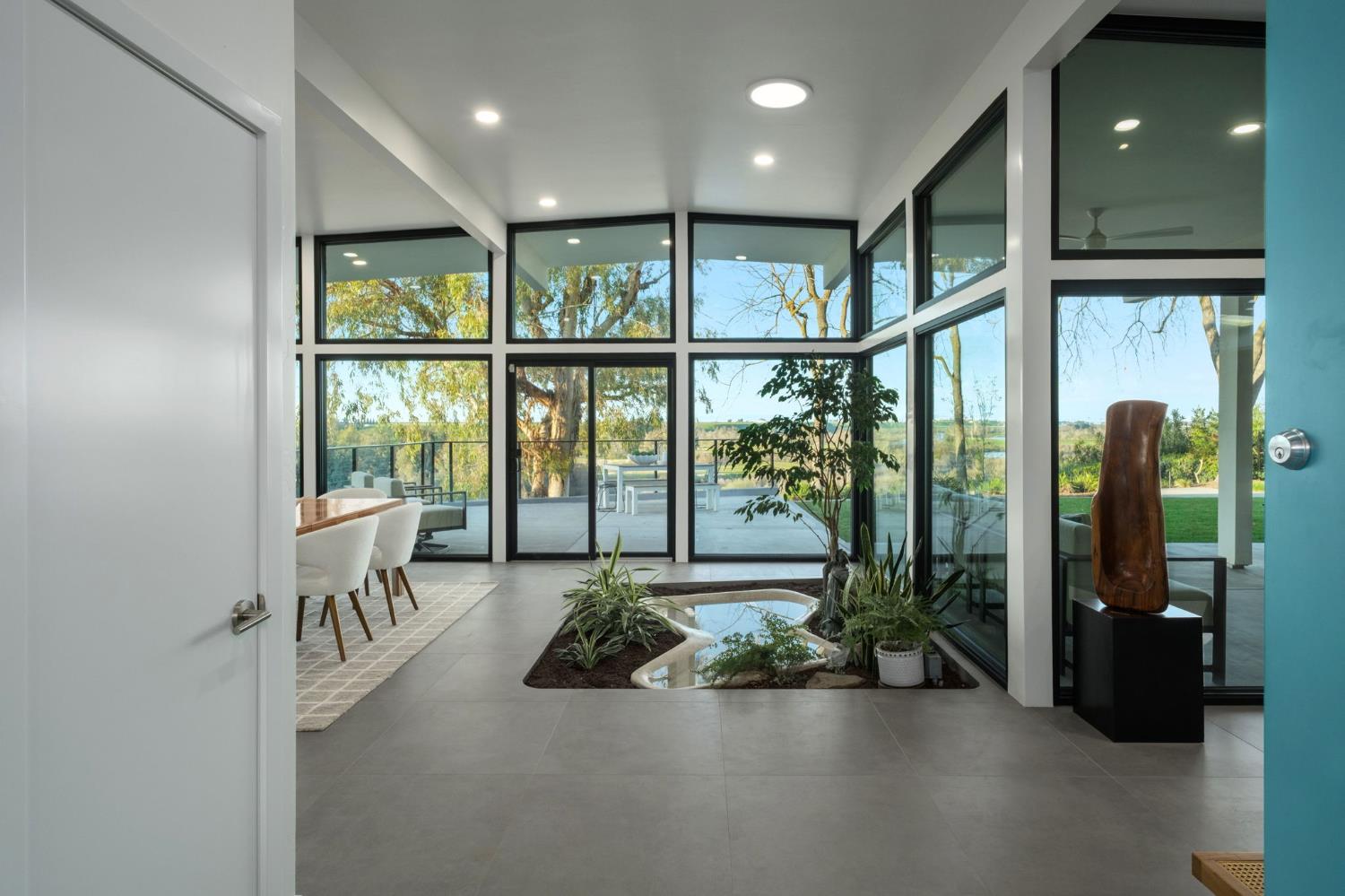 1230 West Moraga Road Fresno, CA 93711 - Photo 11 of 66 a view of a hallway with wooden floor and windows
