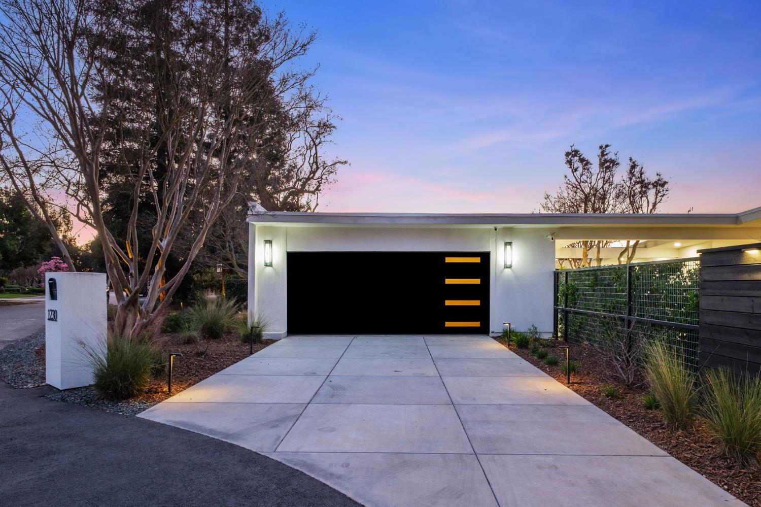 1230 West Moraga Road Fresno, CA 93711 - Photo 3 of 66 a front view of a house with a yard and garage