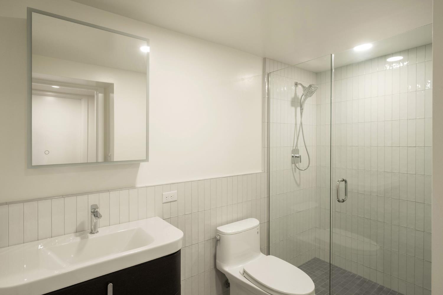 1230 West Moraga Road Fresno, CA 93711 - Photo 41 of 66 a bathroom with a toilet sink shower and mirror