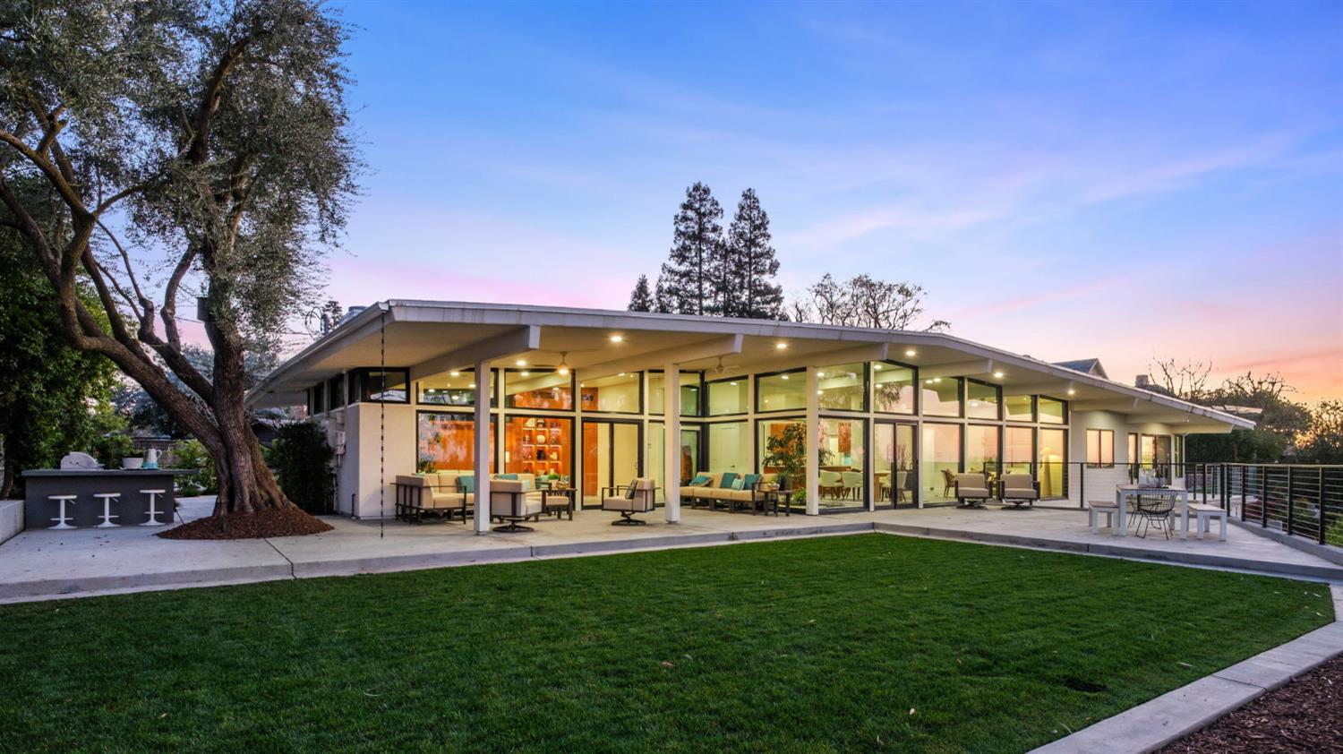 1230 West Moraga Road Fresno, CA 93711 - Photo 49 of 66 a view of an apartment with a table and chairs under an umbrella