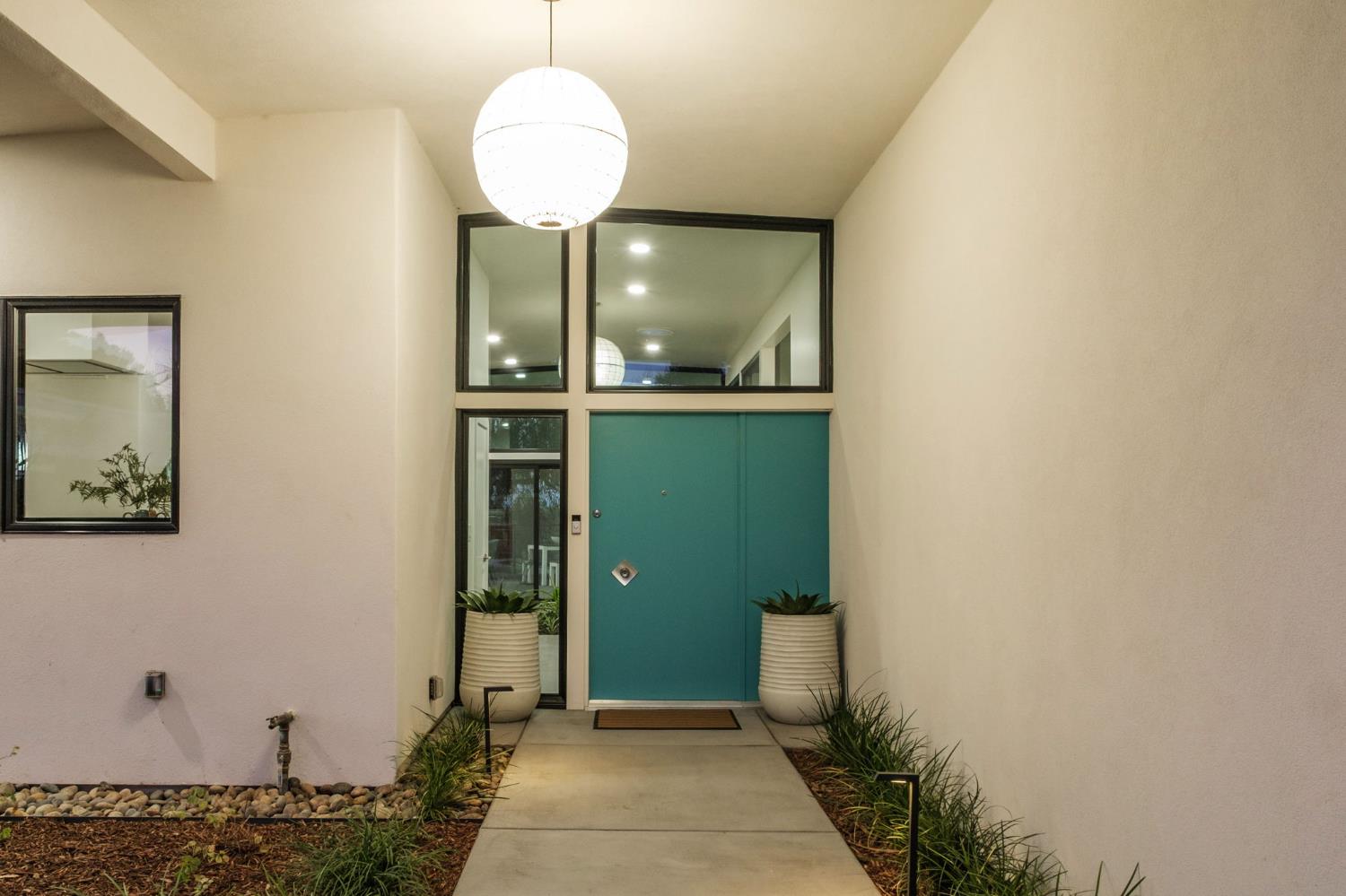 1230 West Moraga Road Fresno, CA 93711 - Photo 10 of 66 a view of a hallway with wooden floor and a bathroom