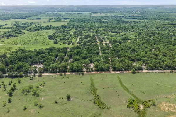 an aerial view of a houses with a yard