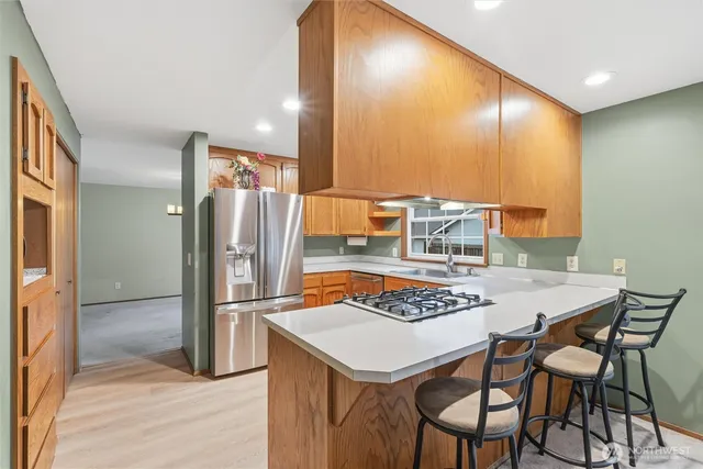 a kitchen that has a sink a stove and cabinets