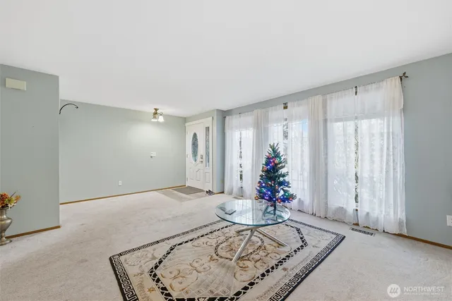 a view of a livingroom with furniture and a window