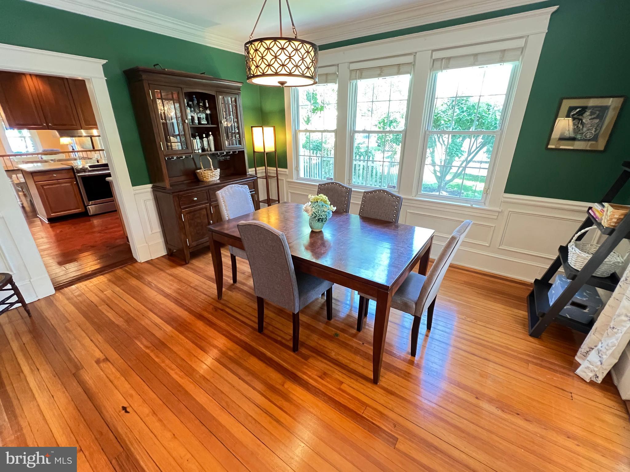 6206 Pinehurst Road Baltimore, MD 21212 - Photo 11 of 80 a view of a dining room with furniture a chandelier and wooden floor