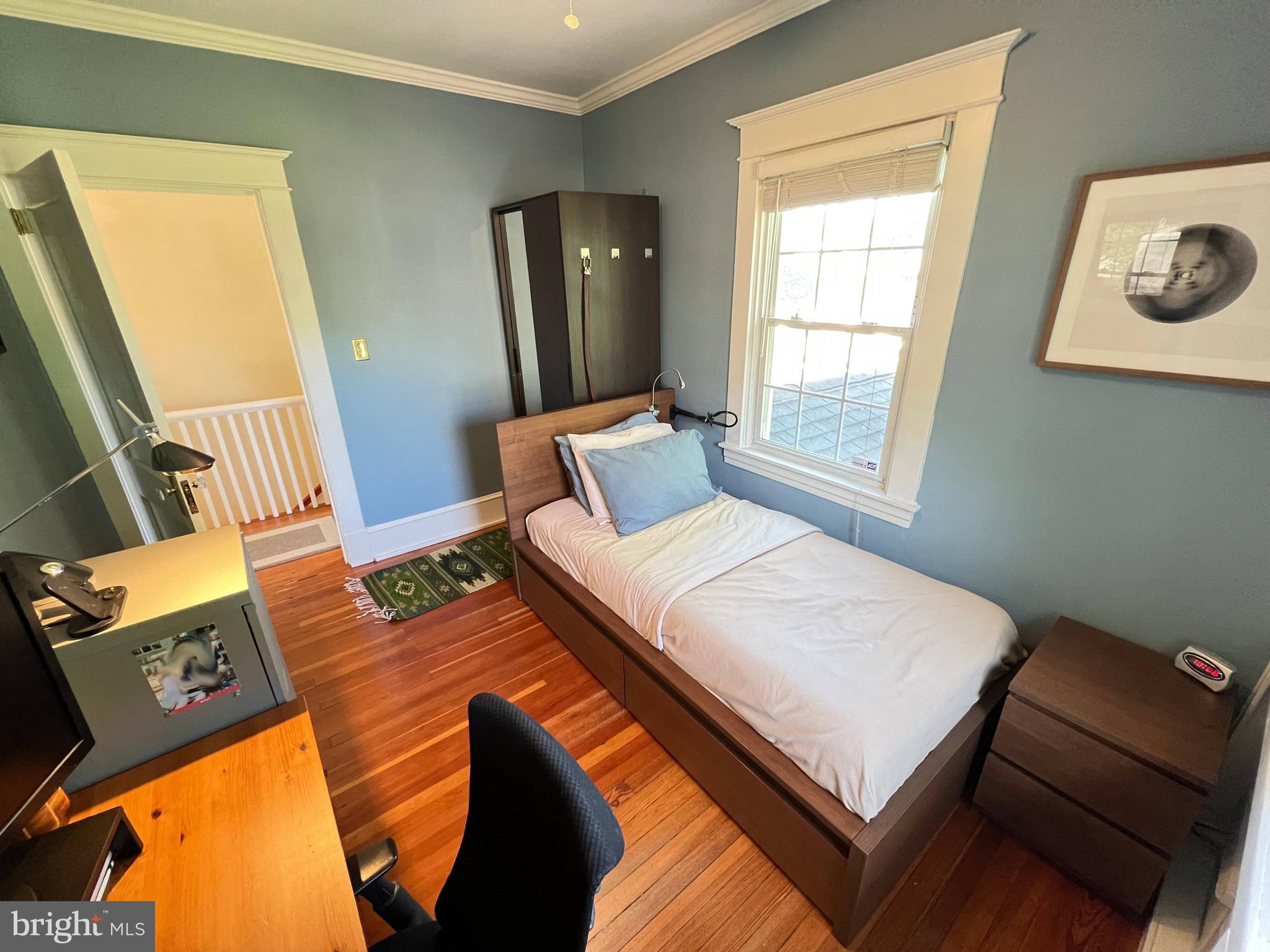 6206 Pinehurst Road Baltimore, MD 21212 - Photo 49 of 80 a bedroom with a bed and wooden floor