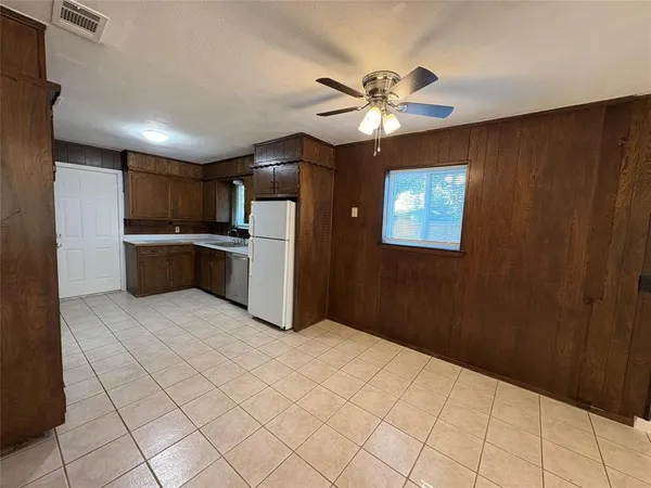a kitchen with stainless steel appliances a refrigerator and microwave