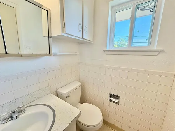 a bathroom with a sink a toilet and mirror