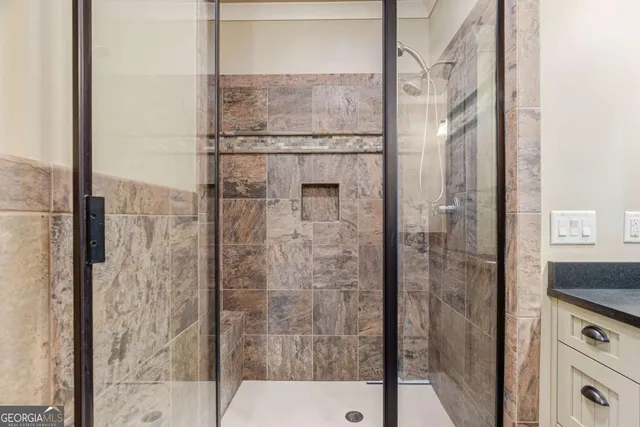 a bathroom with a granite countertop sink toilet a mirror and shower