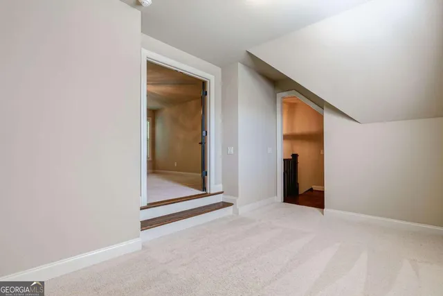 a view of a house with a yard and large trees