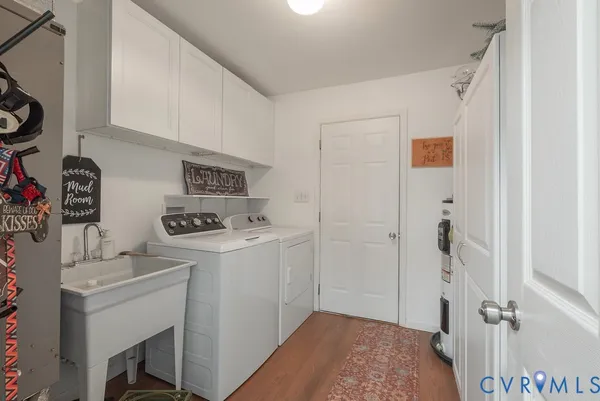 a utility room with sink dryer and washer