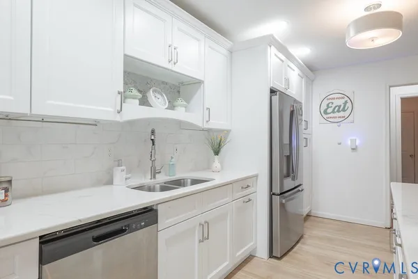 a kitchen with stainless steel appliances a refrigerator and cabinets