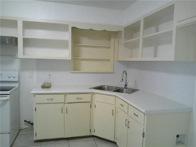 a kitchen with a sink cabinets and a window