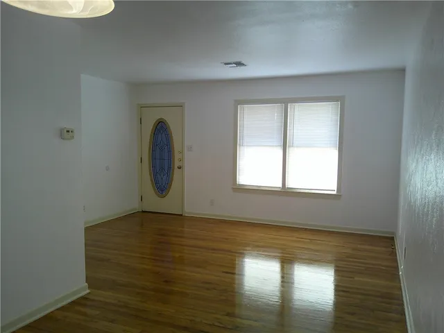 a view of room with window and wooden floor