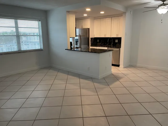 a kitchen with stainless steel appliances a sink a stove a microwave and cabinets