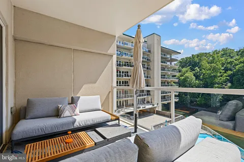 a balcony with furniture and city view