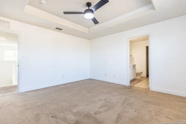 an empty room with a ceiling fan and a window