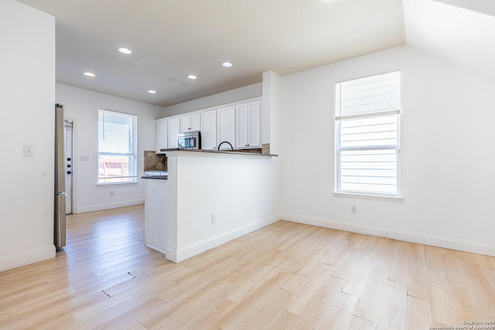 443 Harvest Point Selma, TX 78154 - Photo 7 of 33 a view of a kitchen with wooden floor and a window