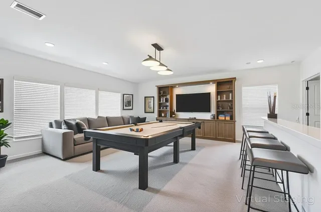 a living room with furniture a flat screen tv and a table