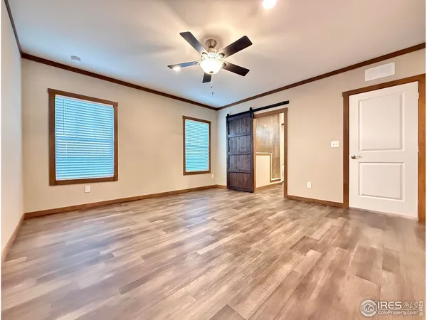 a view of an empty room with window and cabinet